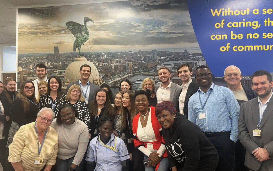 Team gathered in the new office for a fundraiser for Marie Curie