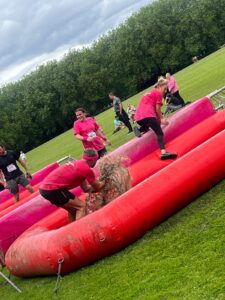 Image shows staff in the pretty muddy race