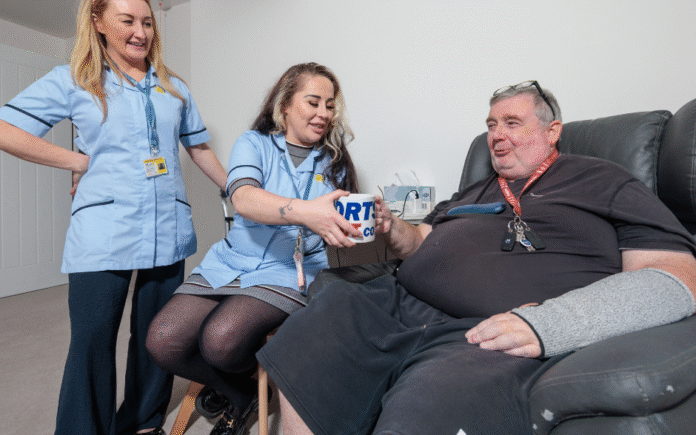 shows two Merseycare Julie Ann workers providing care for a service user