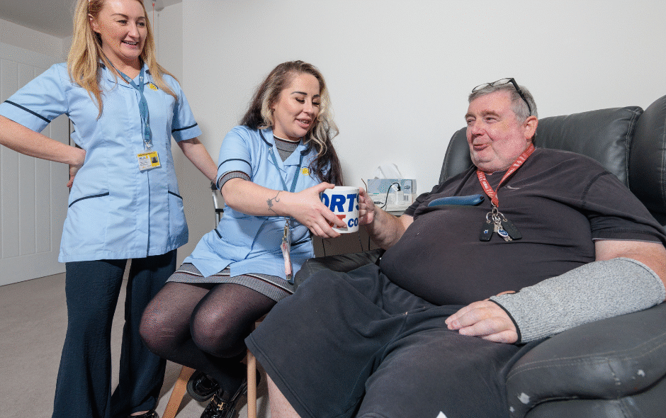 shows two Merseycare Julie Ann workers providing care for a service user