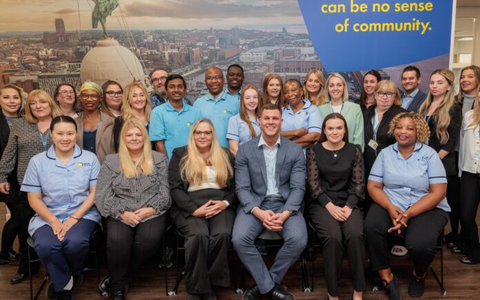 A large group of staff in an office setting.