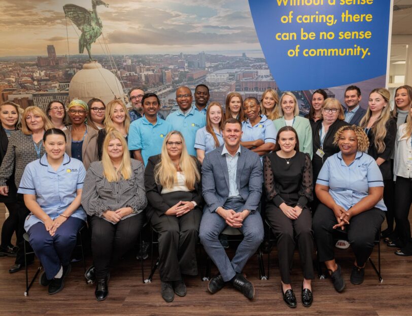 A large group of staff in an office setting.