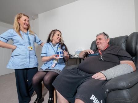 Image shows two carers providing home care for a service user