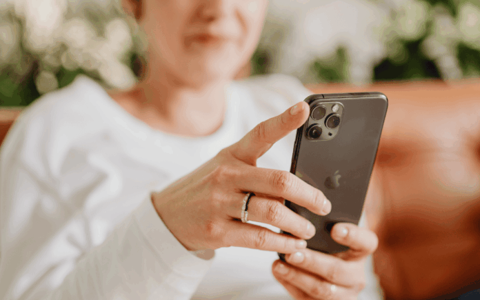 Woman wearing white looking at her phone