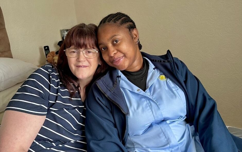 Carer and service user sat close together for blog post on rewarding careers in domiciliary care